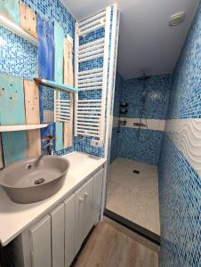 a bathroom with a sink and a shower at La vague in Camiers +5 photos