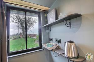 a window in a room with a sink at Chez patricia in Ploubazlanec