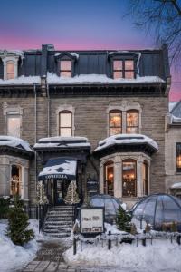 a large brick building with snow on it at Hôtel Boutique Ophelia - Par Aneyro in Quebec City