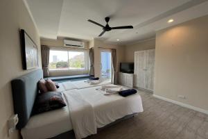 a bedroom with two beds and a ceiling fan at Surf & Sand Resort in Hua Hin