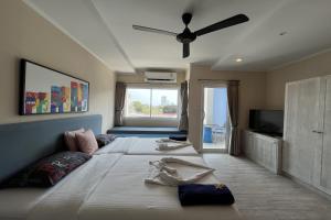 a bedroom with two beds and a ceiling fan at Surf & Sand Resort in Hua Hin +45 photos