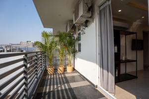 a balcony with potted plants on the side of a building at The Hi-Rise in Gurgaon