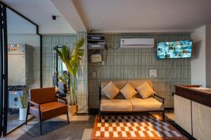a living room with a couch and a chair at The Hi-Rise in Gurgaon
