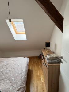 a attic bedroom with a bed and a skylight at Central in Pančevo