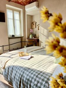 a bedroom with a bed with yellow flowers on it at B&B Barba Vigin in San Damiano dʼAsti