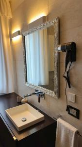 a bathroom with a sink and a mirror at Giulia By The Sea in Follonica
