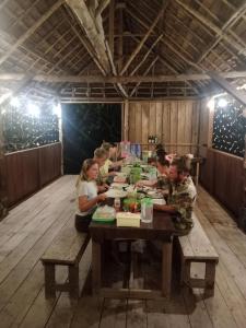 a group of people sitting at a long table at Mares Homestay-Raja Ampat in Fam