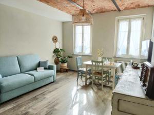 a living room with a couch and a table at B&B Barba Vigin in San Damiano dʼAsti