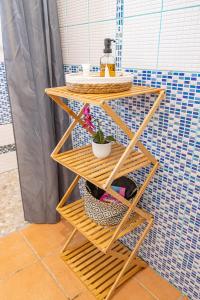 a bamboo shelf with a potted plant on it at Kaz KOKOYE in Baie-Mahault +66 photos
