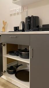 a kitchen with a counter with pots and pans at وسط المدينة للشقق السكنيه in Medina +23 photos