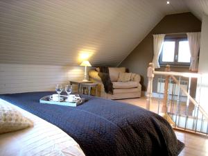 a bedroom with a bed and a living room at Under Oaks in Westmalle