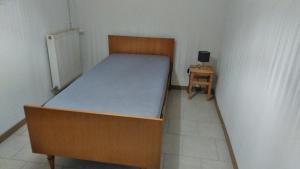 a small bedroom with a bed and a small table at Le Gîte de Mayac,16 rue du four à pain, 24600 VILLETOUREIX FRANCE in Villetoureix