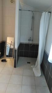 a bathroom with a shower with a shower curtain at Le Gîte de Mayac,16 rue du four à pain, 24600 VILLETOUREIX FRANCE in Villetoureix