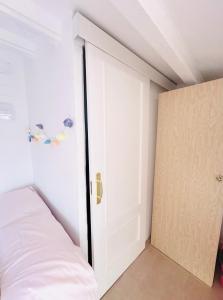 a bedroom with a door leading to a bed at Habitación con baño y cocina in Caudiel