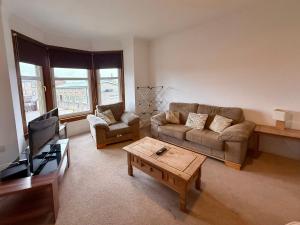 a living room with a couch and a coffee table at The Orchard Hotel in Falkirk
