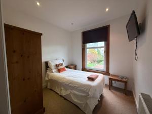 a bedroom with a bed and a window at The Orchard Hotel in Falkirk