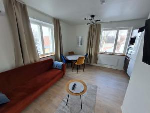 a living room with a couch and a table at Kuressaare kesklinn, Turu Apartment in Kuressaare