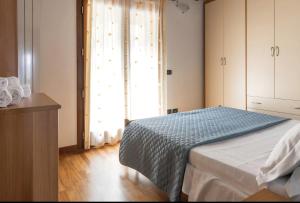 a bedroom with a bed and a large window at La Magia del Lago in Ranzanico +15 photos