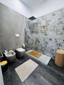 a bathroom with a shower and a toilet and a sink at Affittacamere il Conte Rooms in Pescara