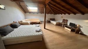 a bedroom with a bed and a living room at Kulata Predel in Razlog