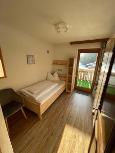 a small bedroom with a bed and a window at Gästehaus Hauser in Bach