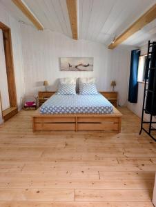 a bedroom with a large bed in a room at Le Chant des Arbres in Grane
