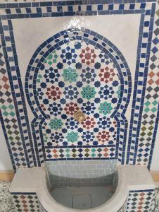 a bathroom with a mosaic tile wall with a tub at Marrakesh Classic House 20 in Marrakesh