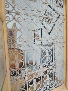 a white wall with a gate in a room at Marrakesh Classic House 20 in Marrakesh