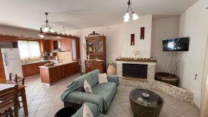 a living room with a couch and a fireplace at KAZARMA Luxury House in Pilikáta