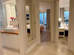 a bathroom with a sink and a mirror at Salig Hüs in Kampen +29 photos