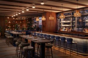 a restaurant with tables and chairs and a bar at ROOST Rainey in Austin