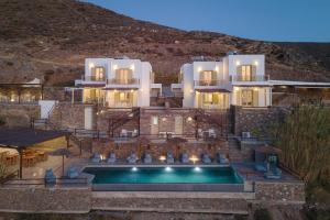a house with a swimming pool in front of it at Kastella Sunset Villa Three in Kithnos