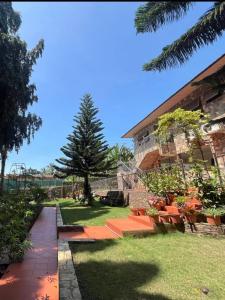 a garden with orange benches in front of a building at Aburi Emerald Garden Retreat in Aburi