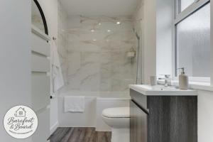 a white bathroom with a toilet and a shower at Contractor friendly 3BDR Home | Parking for Vans in Salford +22 photos