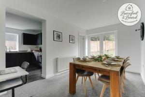 a kitchen and dining room with a table and chairs at Contractor friendly 3BDR Home | Parking for Vans in Salford