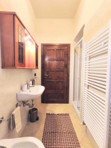 a bathroom with a sink and a toilet and a door at I sogni di Elias in Tuoro sul Trasimeno +56 photos