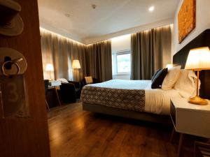 a hotel room with a bed and a window at Casa do Rio in Termas de Sao Pedro do Sul