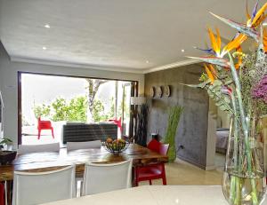a dining room with a table and chairs at BushGlam Luxury Holiday Home in Hoedspruit