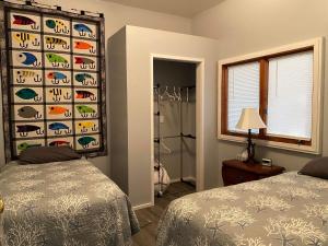 a bedroom with two beds and a shower at Rudolph's Reindeer Den in Ketchikan