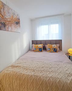 a bed with two pillows on it in a bedroom at City Square, center in Subotica
