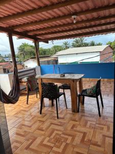 a wooden table and chairs on a patio at Prédio AZUL in Itacaré +22 photos
