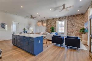 a large kitchen and living room with a brick wall at Harbor House Penthouse- B in Key West