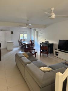 a living room with a couch and a table at La jolie Villa in Le Lamentin