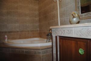 a bathroom with a tub and a sink at A&M House in Vignanello