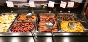 a buffet of different types of food with spoons at Bryce View Lodge Part of the Ruby's Inn Resort in Bryce Canyon