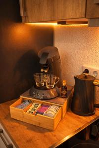 a kitchen counter with a blender on a table at CitySuite Borken Hessen in Borken
