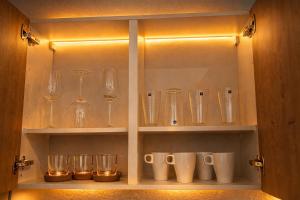 a cabinet filled with glasses and wine glasses at CitySuite Borken Hessen in Borken