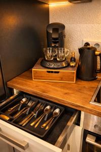 a kitchen counter with a coffee maker on top of a stove at CitySuite Borken Hessen in Borken