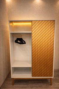 a walk in closet with wooden panels and shoes in it at CitySuite Borken Hessen in Borken