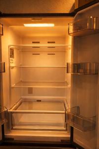 an empty refrigerator with its door open in a kitchen at CitySuite Borken Hessen in Borken +5 photos